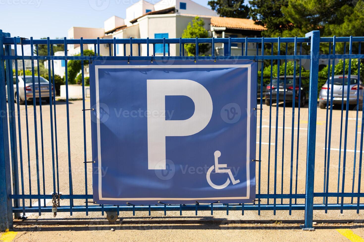 Parking sign on blue gate. Urban accessibility, transportation regulation, and inclusive infrastructure in public spaces photo