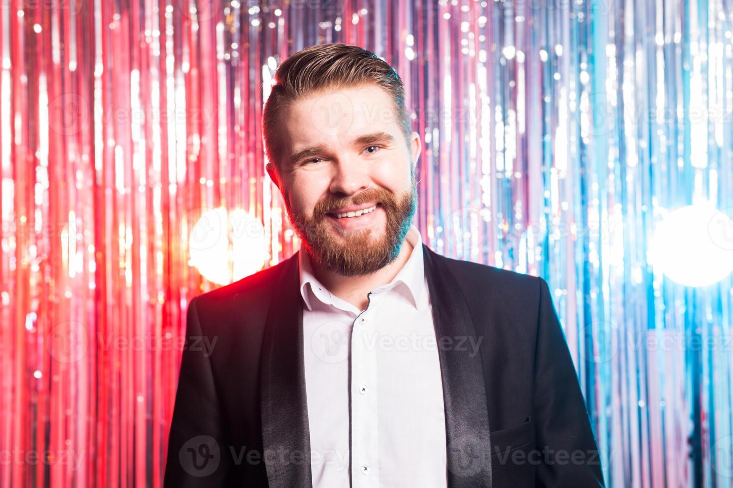 Party and holidays - Portrait of elegant handsome man in a expensive suit on shiny background. photo