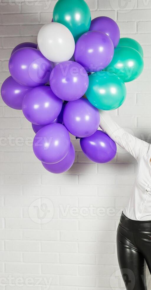 Hand of woman with colored balloons photo