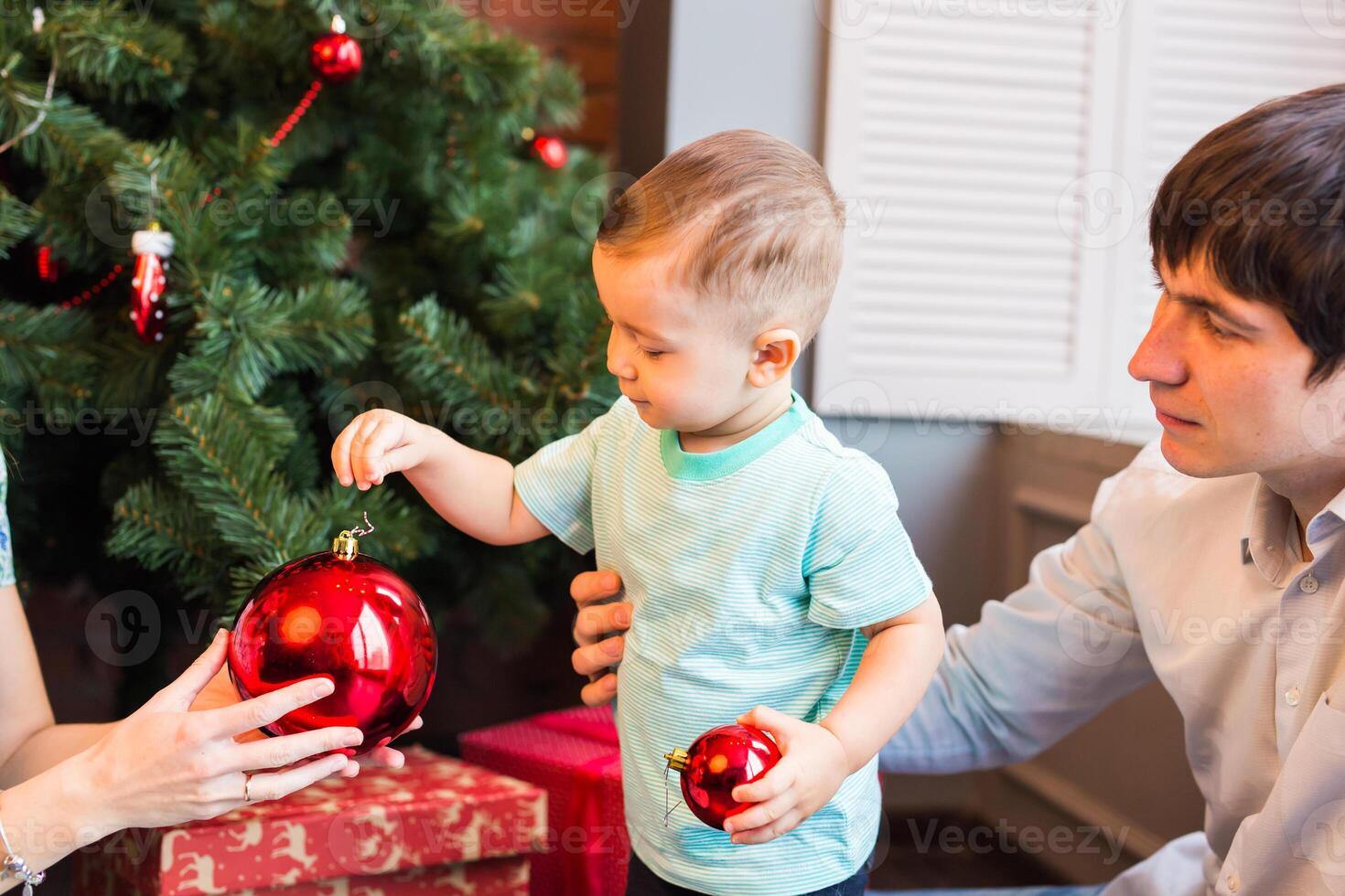 beautiful happy little boy with christmas balls photo