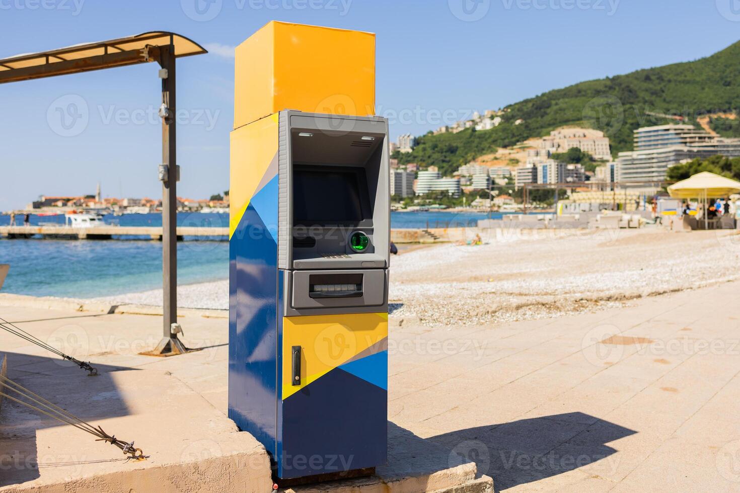ATM near beach promenade. Coastal infrastructure, seaside convenience, and tourism service access photo