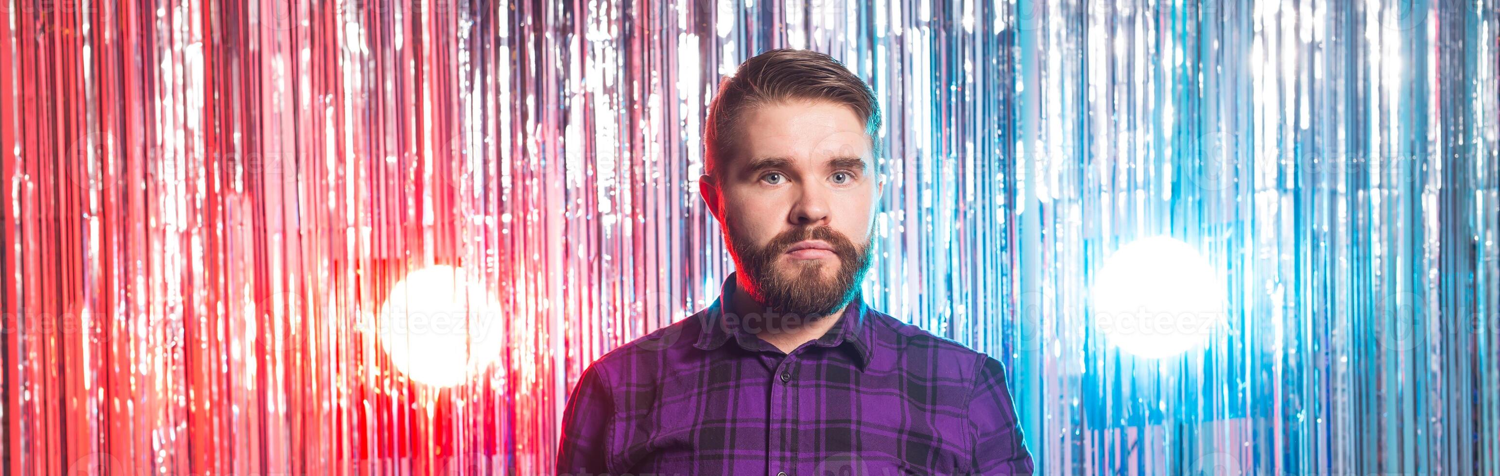 Club party and holidays - Portrait of handsome funny guy on shiny background. photo