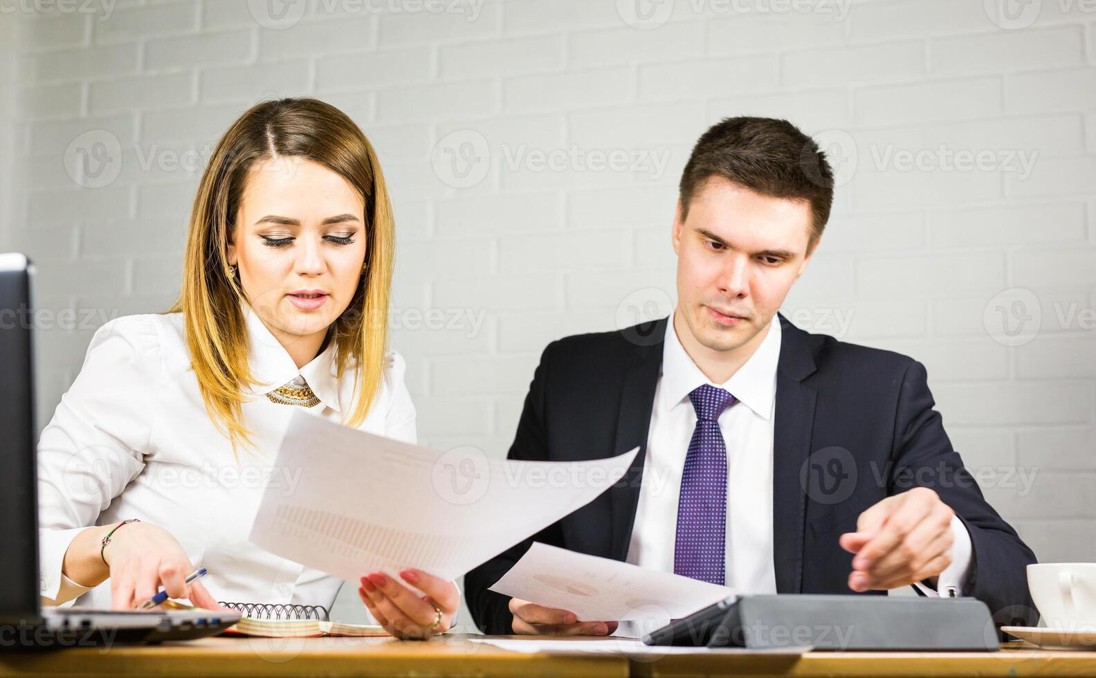 young business colleagues discussing work on a laptop computer in co-working space, corporate businesspeople photo