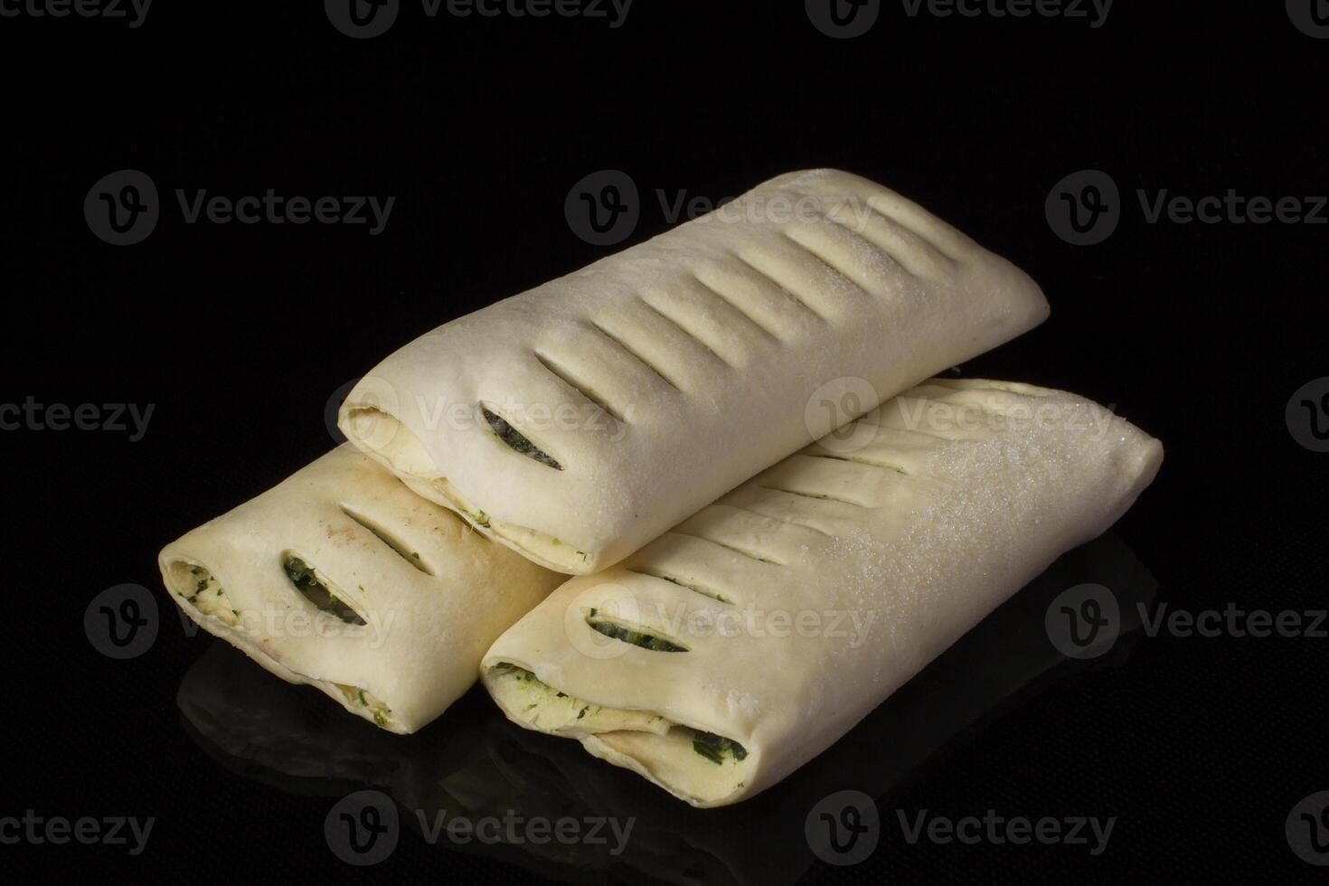 Semi-finished puff pastry with sauce. Baking for baking on a black background photo