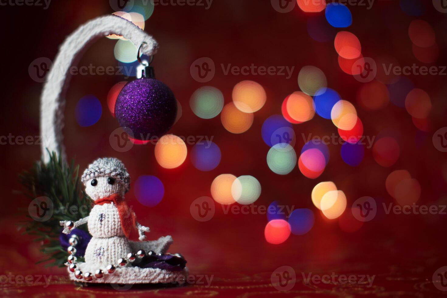 Toy snowman on bokeh background. New Year card. photo