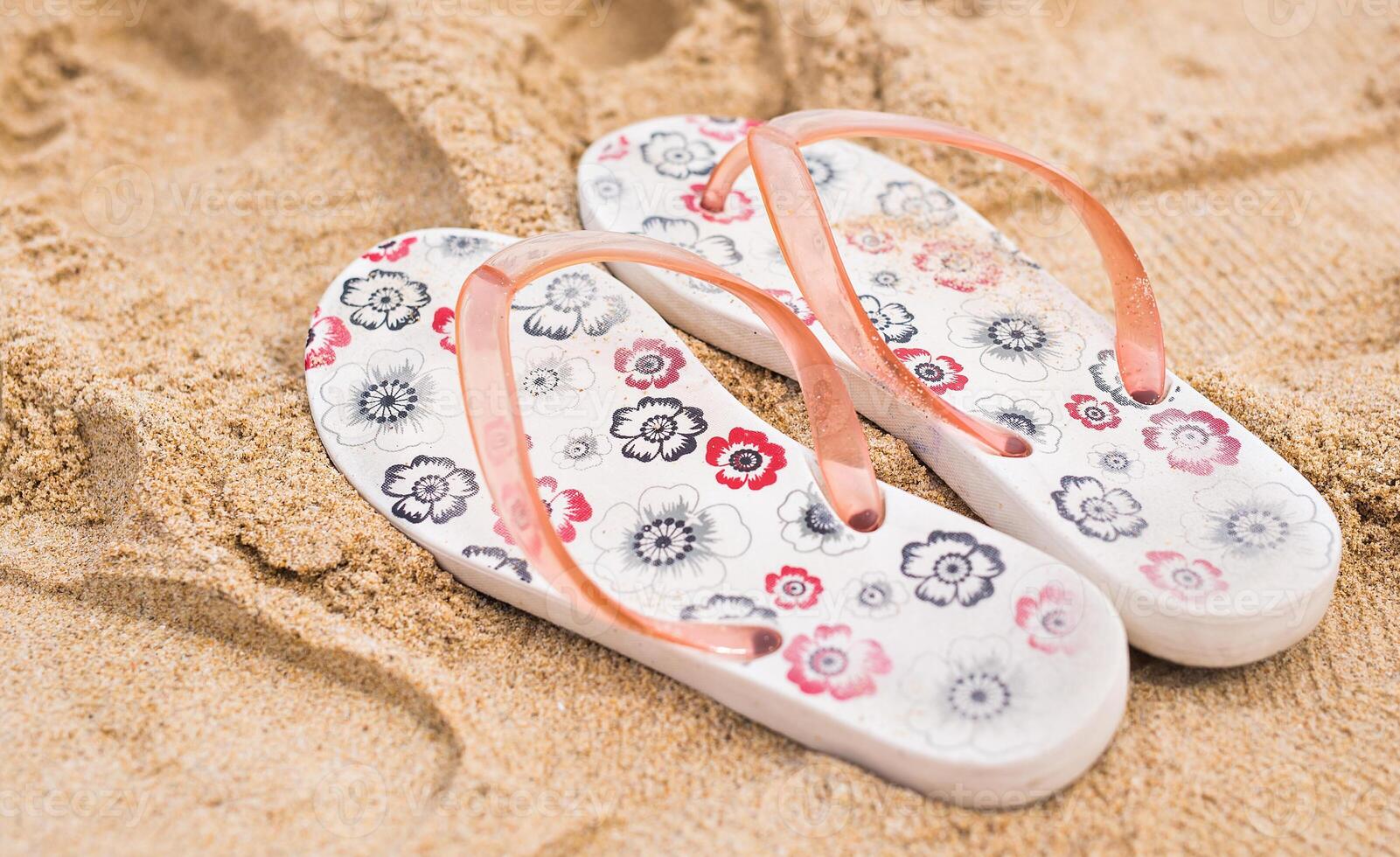 Tropical vacation concept-Flipflops on a sandy ocean beach photo