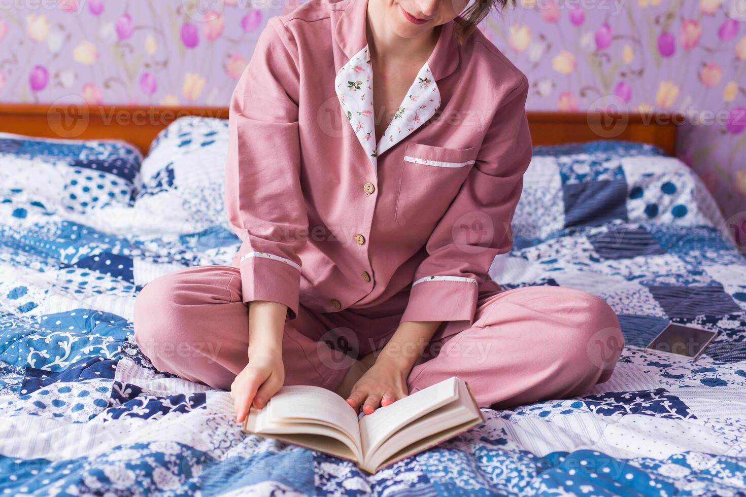 Close-up woman wears pajama and relaxing at home and reading a book. photo