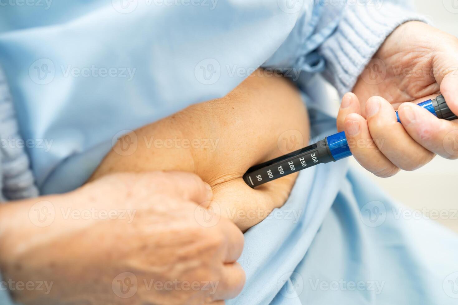 Senior woman patient injecting insulin for diabetes. photo