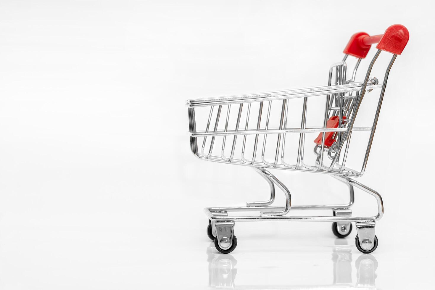 Shopping cart object representing online shopping, ecommerce, retail store, and consumer purchase. Ideal for business, finance, and marketing concept. Isolated on white background. photo