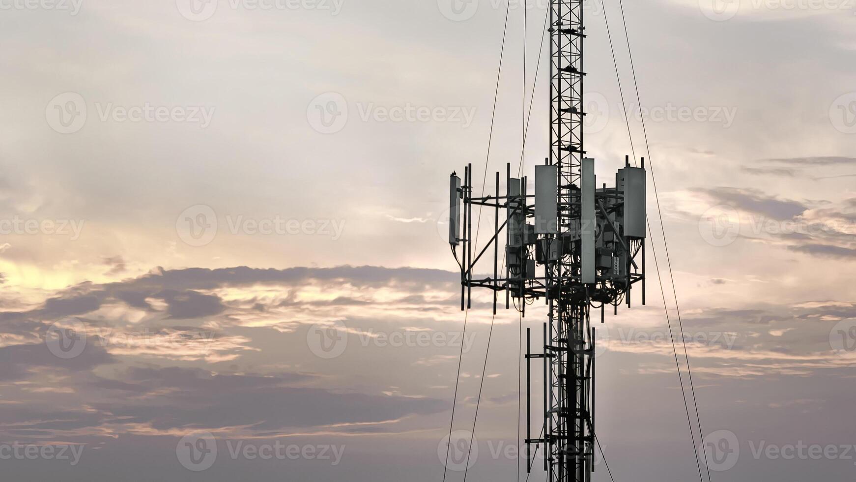 Telecommunication tower with antenna and transmitter for cellular signal, wireless network, and data connection. Infrastructure for high speed internet, and modern communication system photo