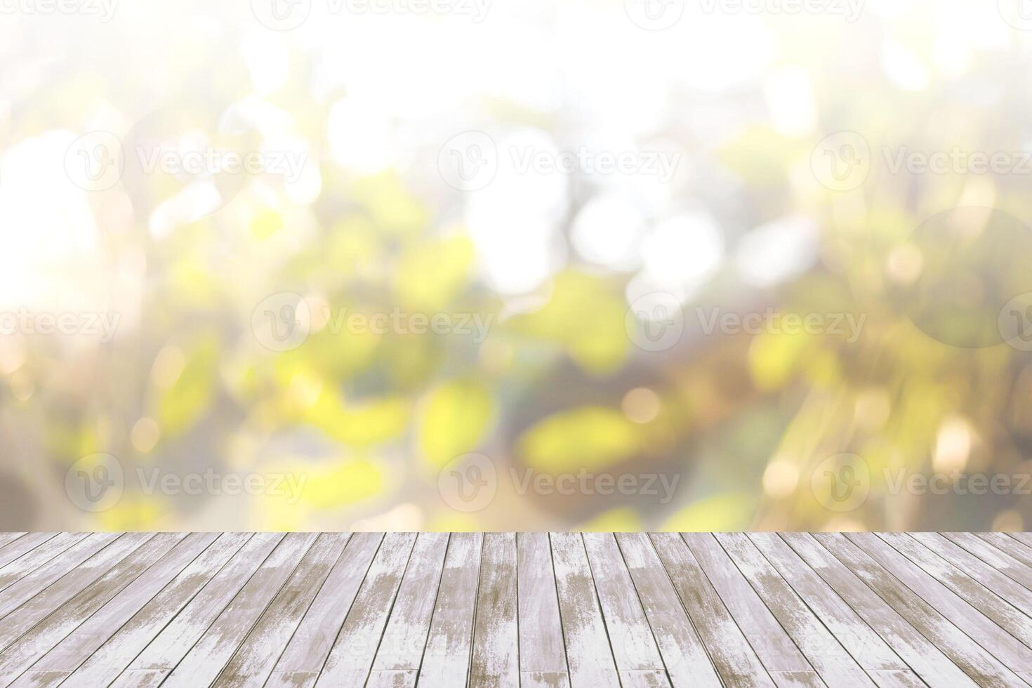 Blurred abstract background of looked-up tree in yellow tone with wooden floor photo