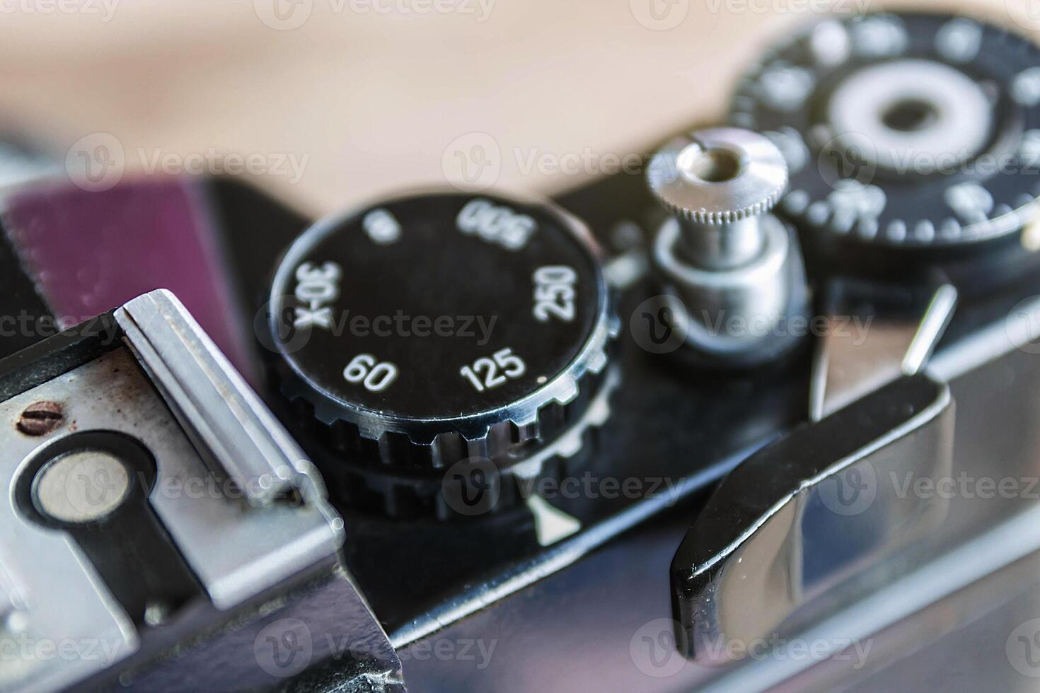 Old film camera, The wheel of choice shutter and shutter button, Close up view at 125 speed shutter, Selective focus, Vintage photo style