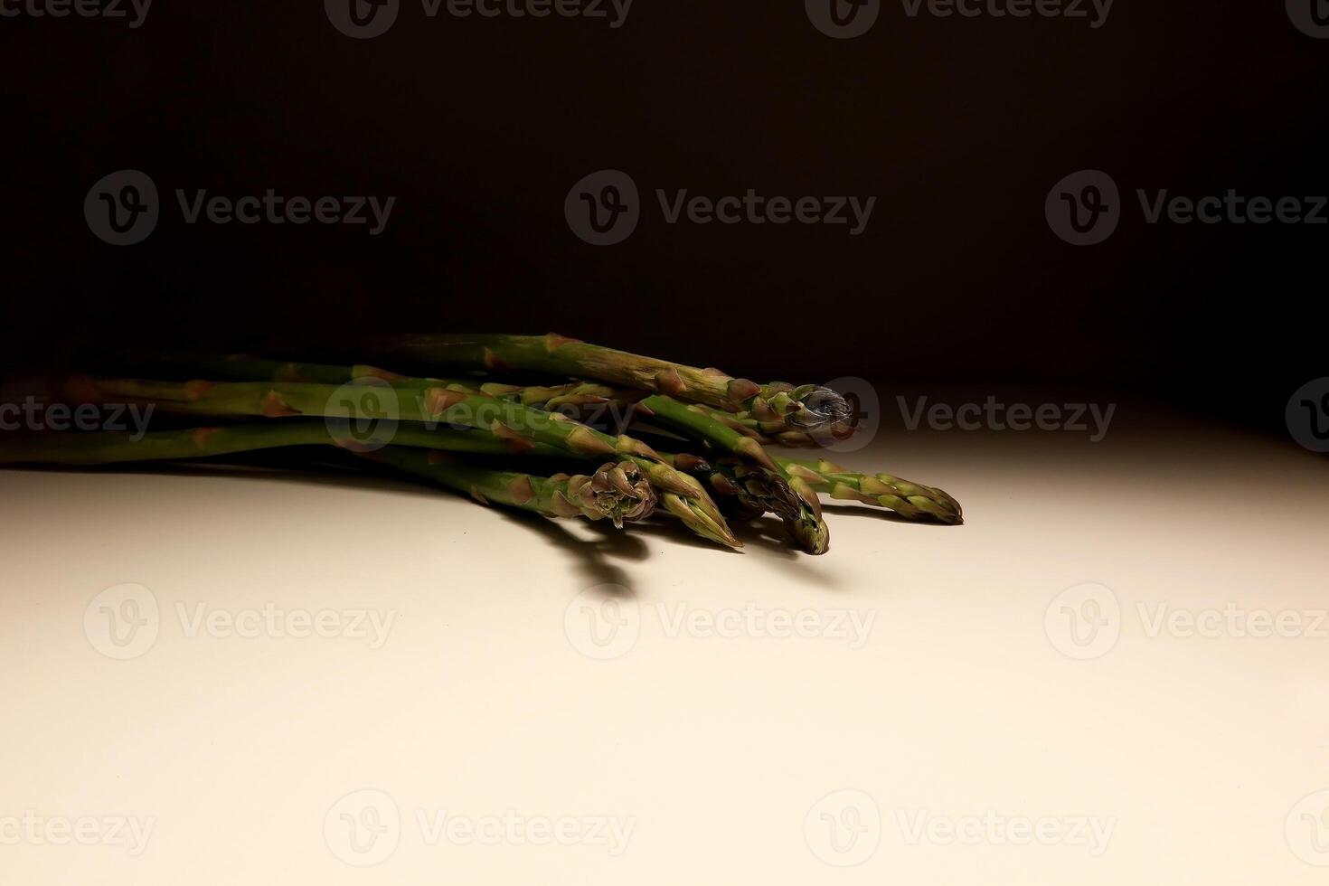 Fresh Green Asparagus Spears on White Table with Minimal Background photo