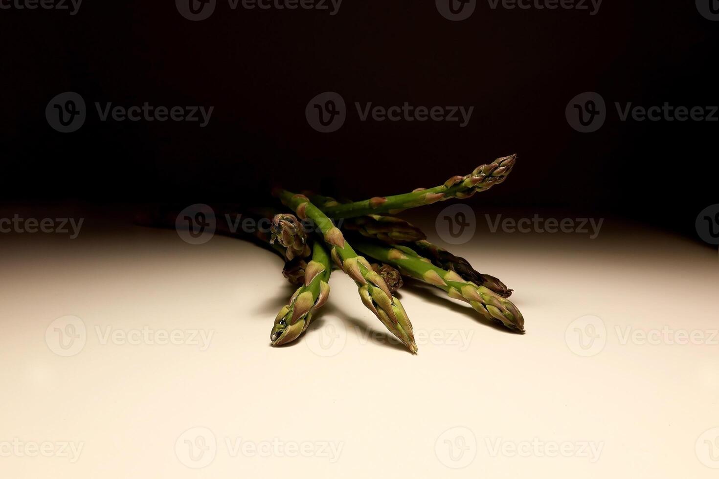 Fresh green asparagus spears on white background with natural light photo