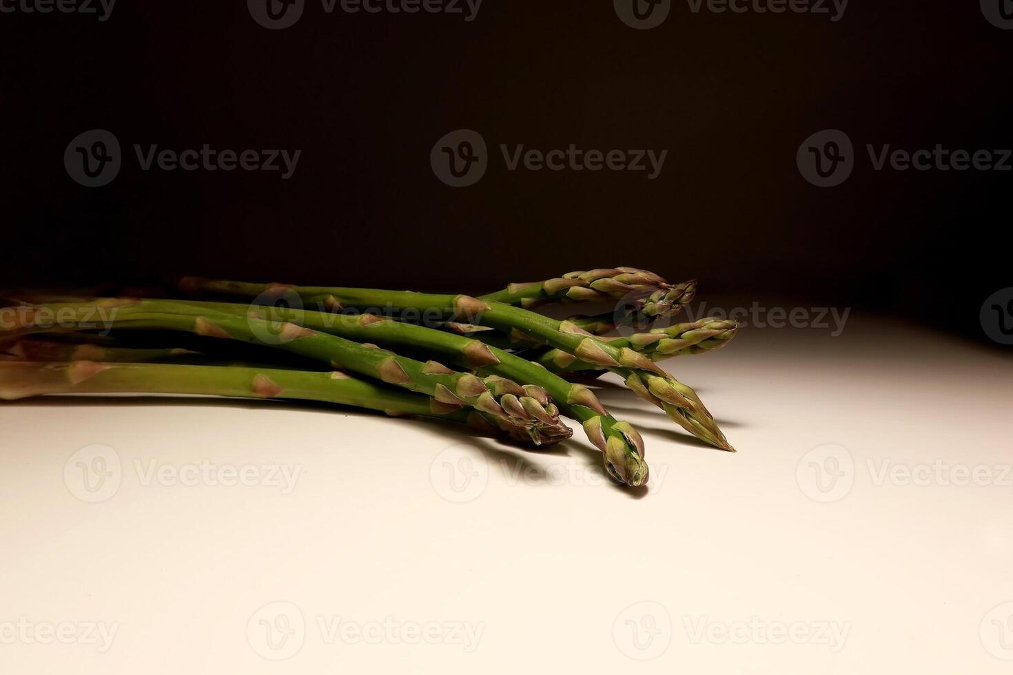 Fresh green asparagus spears on white background in studio lighting photo