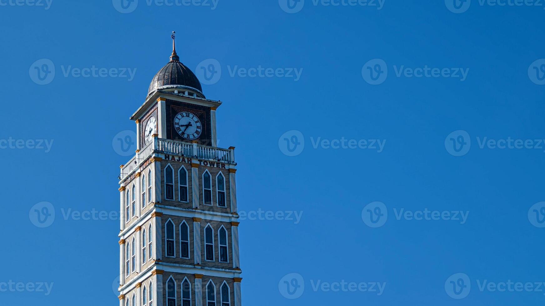 Prominent Mosque Clock Tower Standing Tall Against a Clear Blue Sky in Bogor photo
