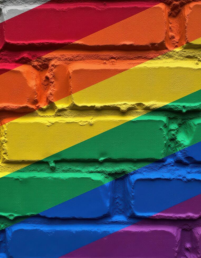 a brick wall with the rainbow flag painted on it photo