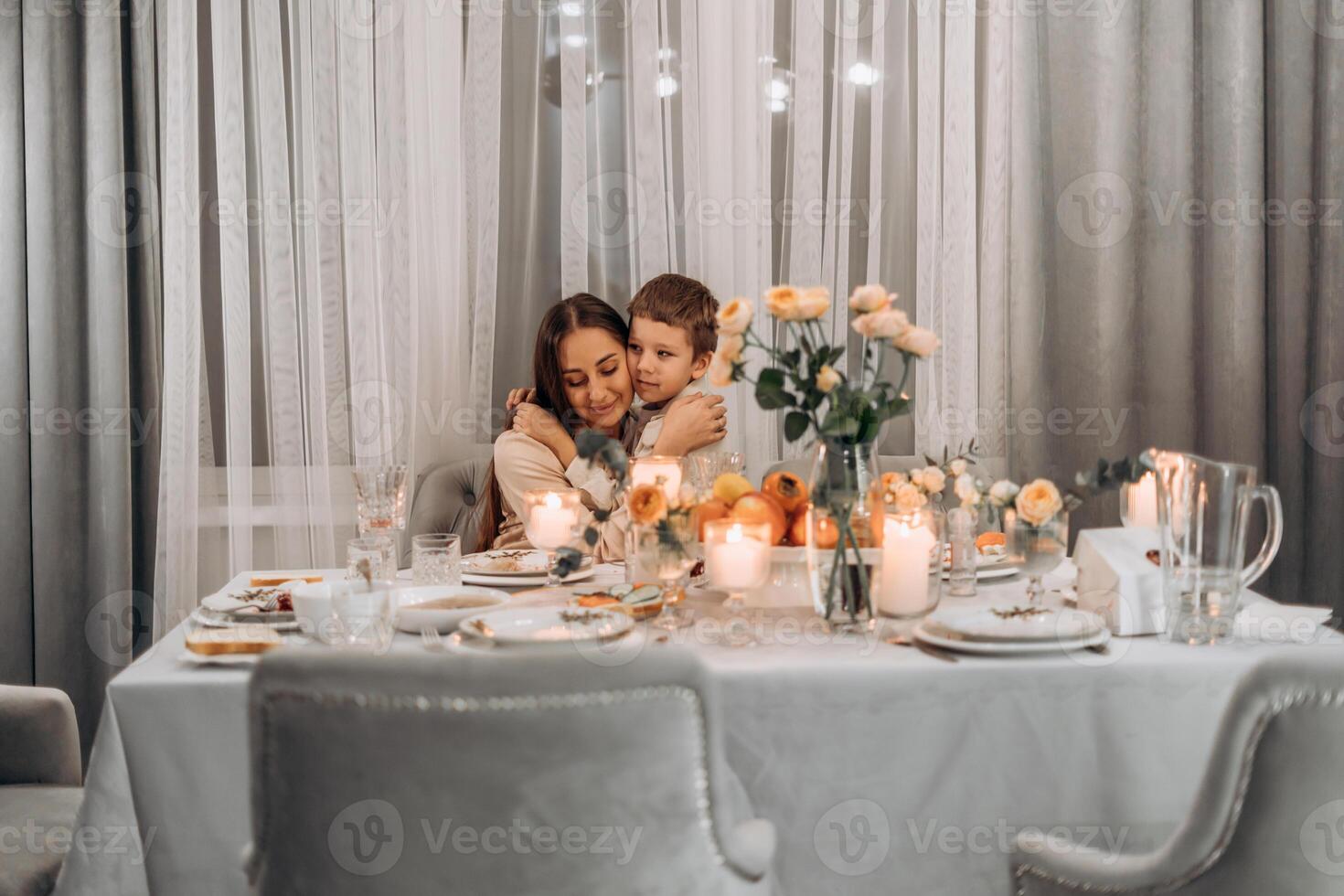 Loving mother gently holding hands of her child in soft candlelight during heartfelt Thanksgiving dinner symbolizing gratitude warmth emotional connection and family traditions celebrated with photo