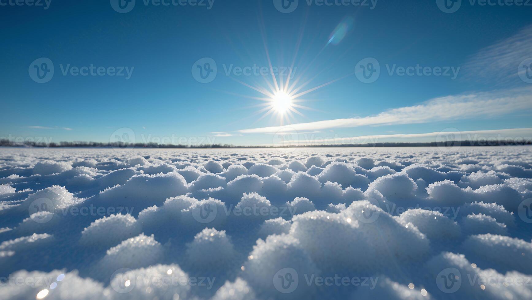 Snow Covered Field Under Bright Winter Sun and Clear Blue Sky photo