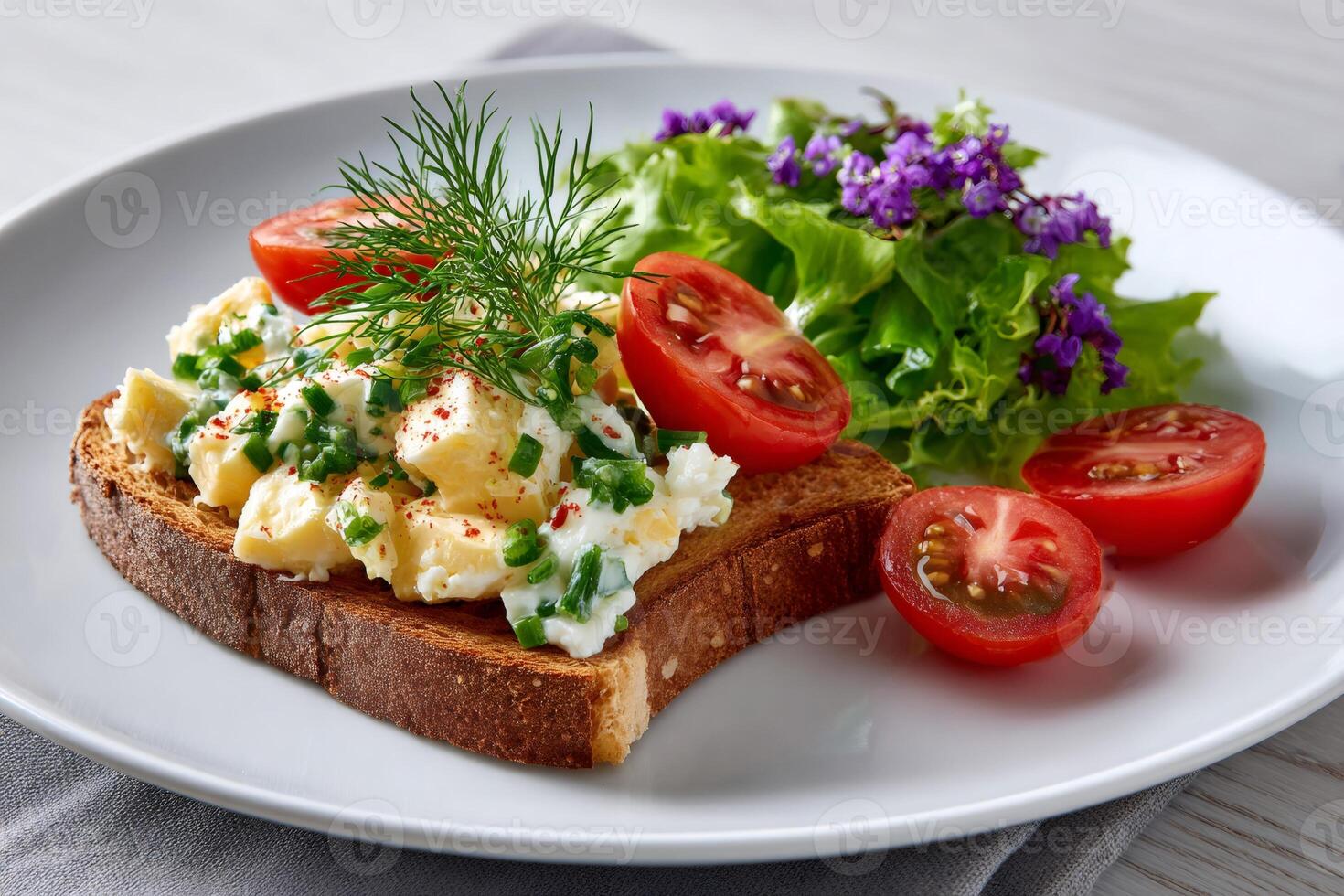Whole wheat toast with chopped boiled eggs and chives seasoned with paprika, tomatoes and lettuce salad, healthy breakfast or snack photo