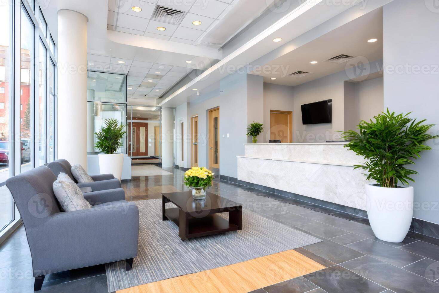Modern office lobby with reception desk and waiting area featuring comfortable seating photo