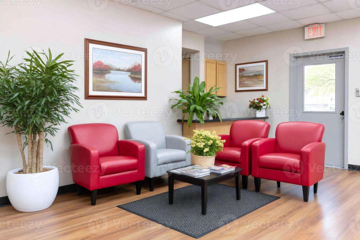 Comfortable waiting room with red armchairs and plants decorating the space photo