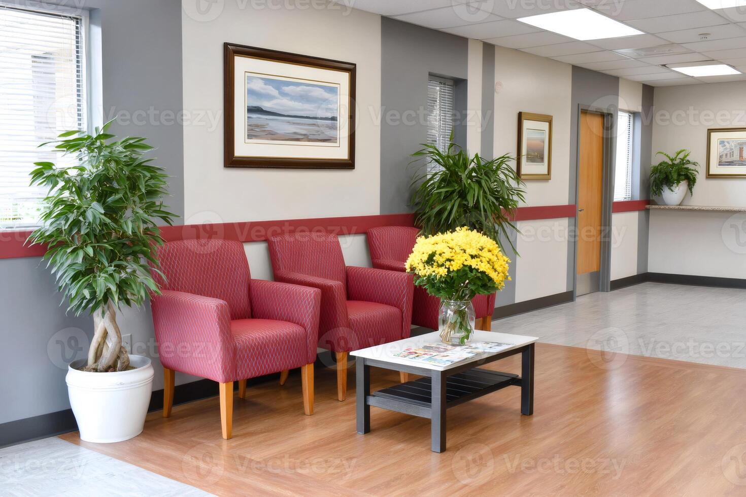 Comfortable waiting room with red chairs, plants, and framed artwork photo