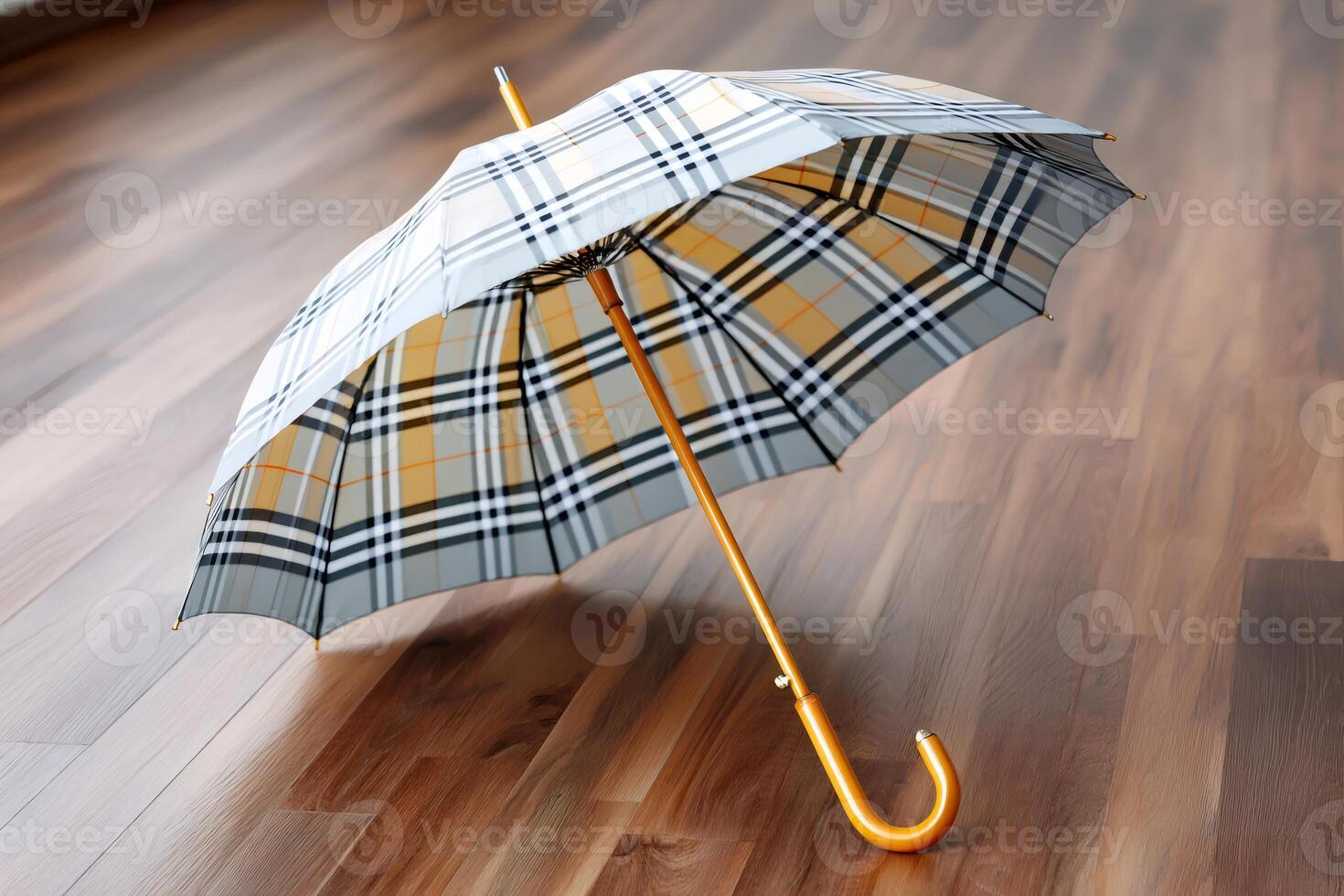 Elegant umbrella with checkered pattern resting on wooden floor photo