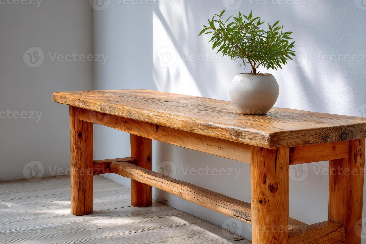 Rustic wooden bench holding a plant pot in a minimalist interior design photo