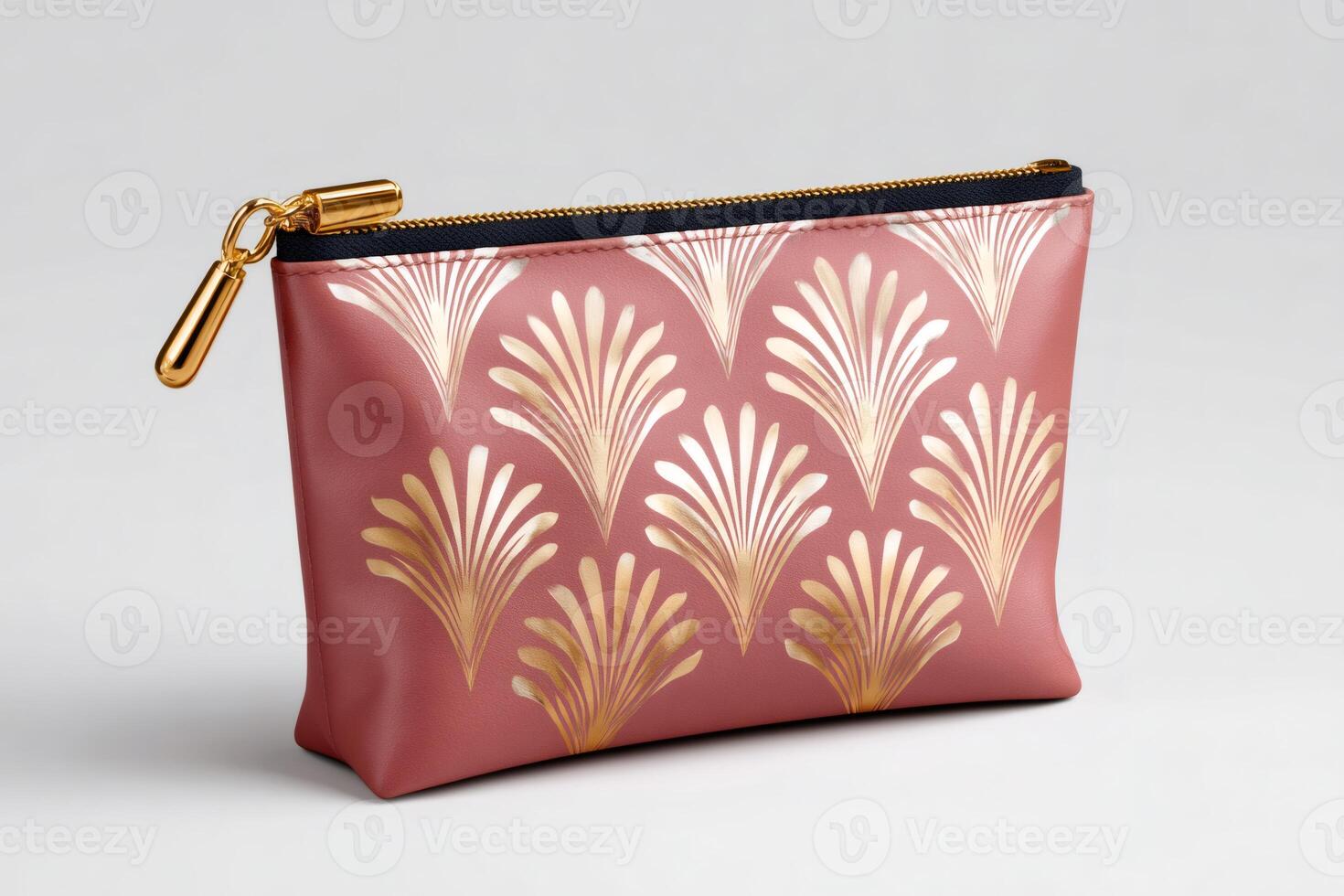 Pink clutch bag with golden palm leaf pattern and gold zipper puller resting on white background photo