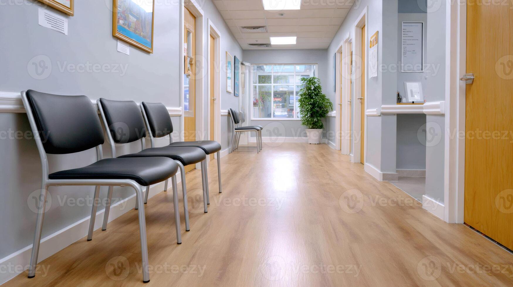 Empty waiting room with chairs and paintings on corridor walls photo
