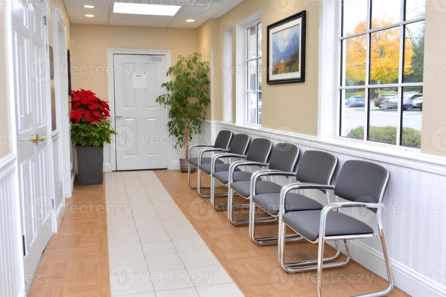 Empty waiting room with chairs, plants and painting representing mountains photo