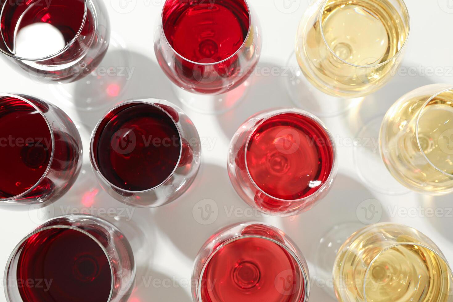 Glasses with different wine on white background, closeup and top view photo