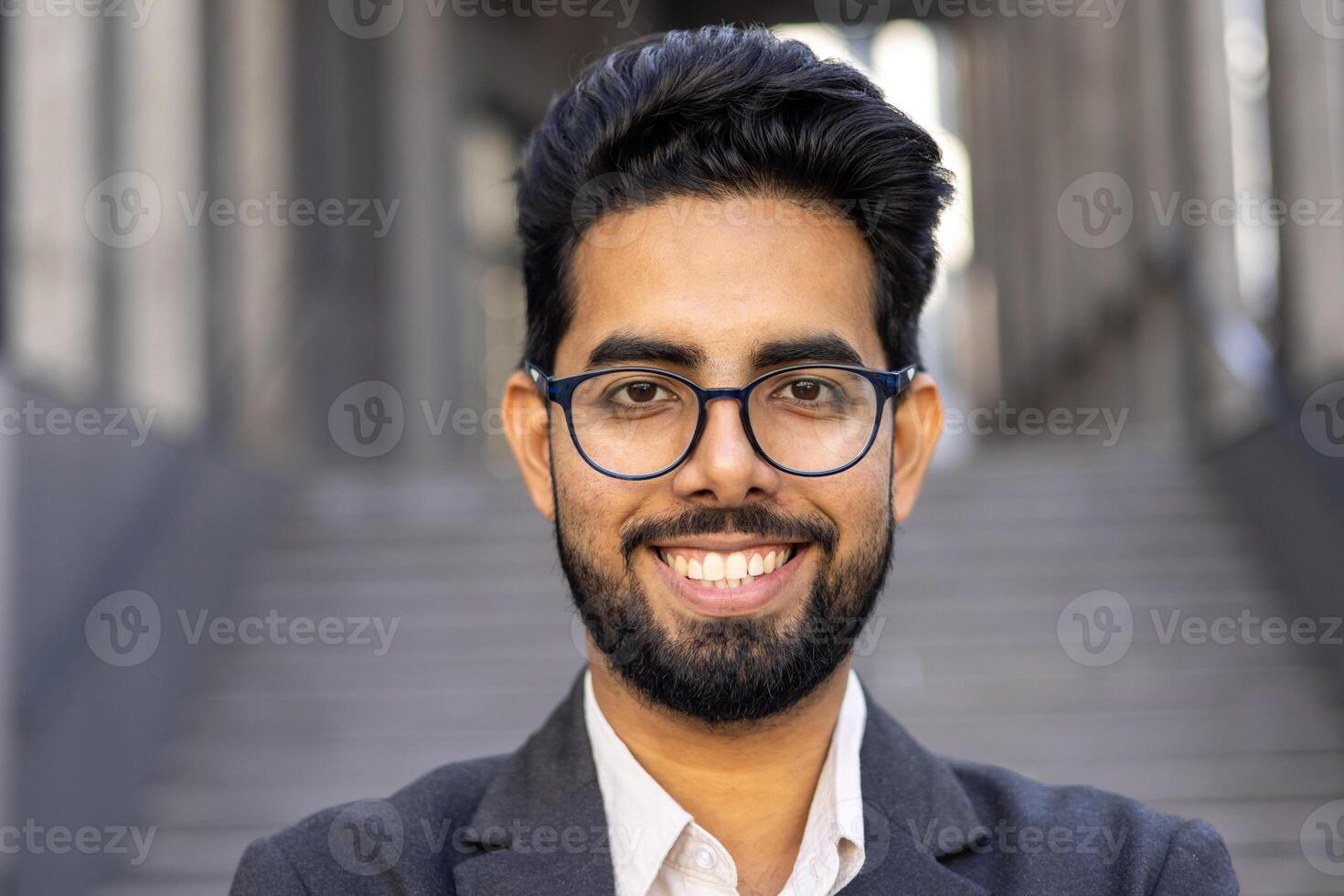 Close up portrait of businessman, man in business suit smiling and looking at camera, successful investor banker outside office building. photo