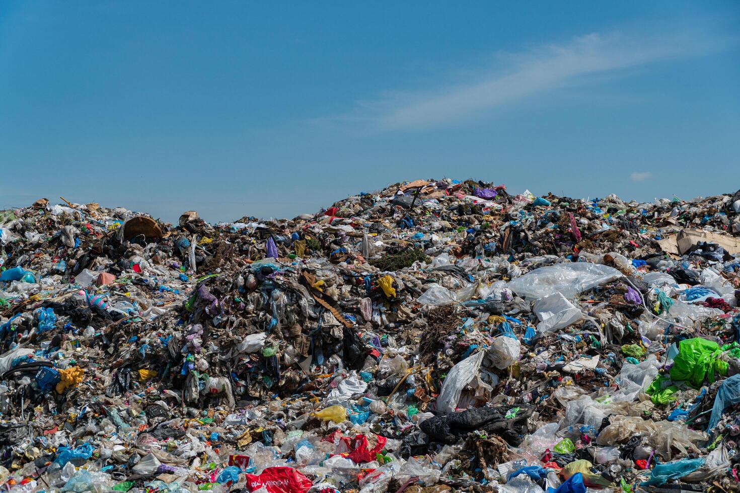 A huge landfill of mixed waste, including plastics, underscores the ongoing battle with pollution and ecological management photo