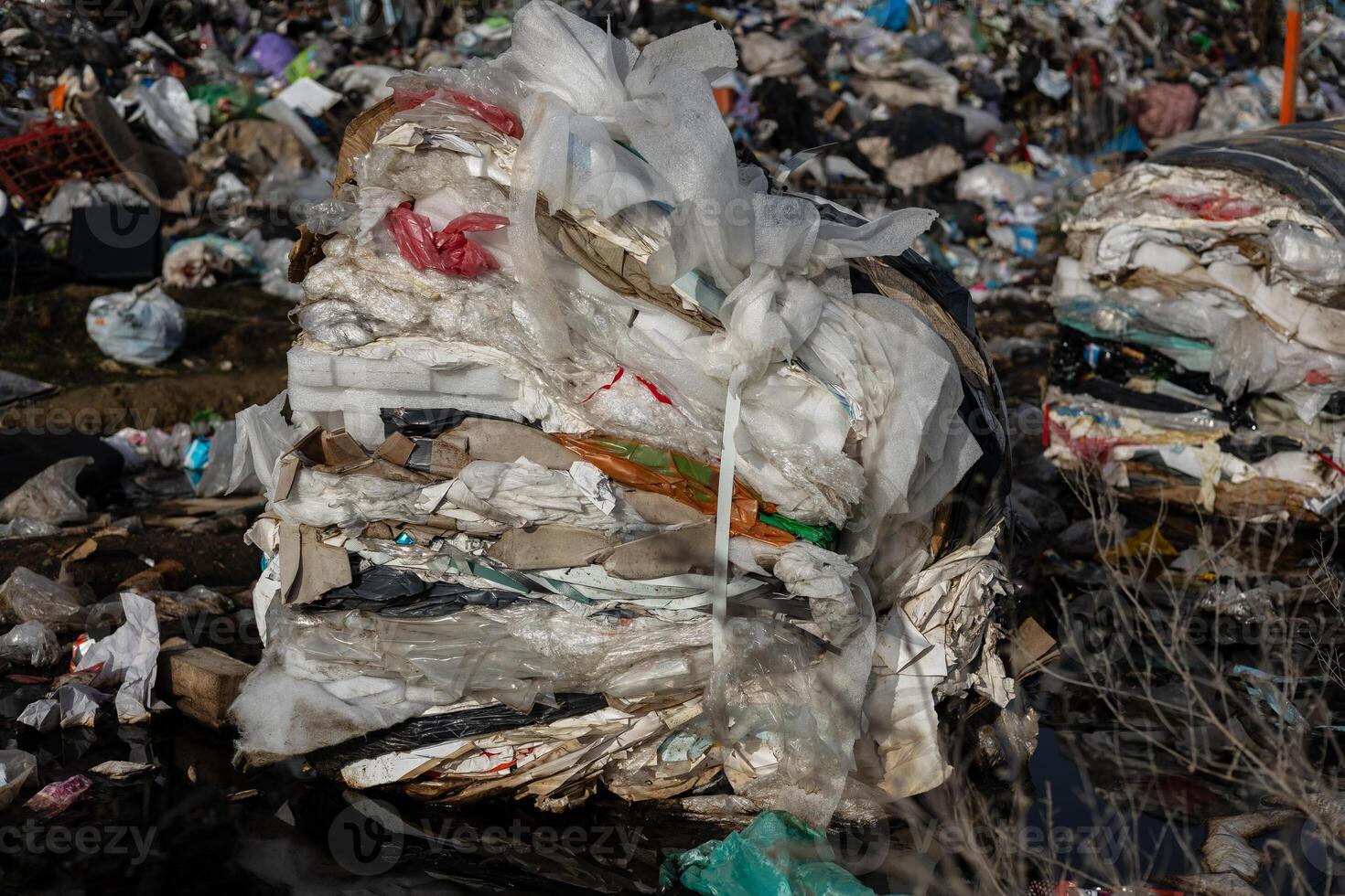 Layers of compacted trash are visible at a landfill site, highlighting the urgent need for better recycling and waste management practices photo