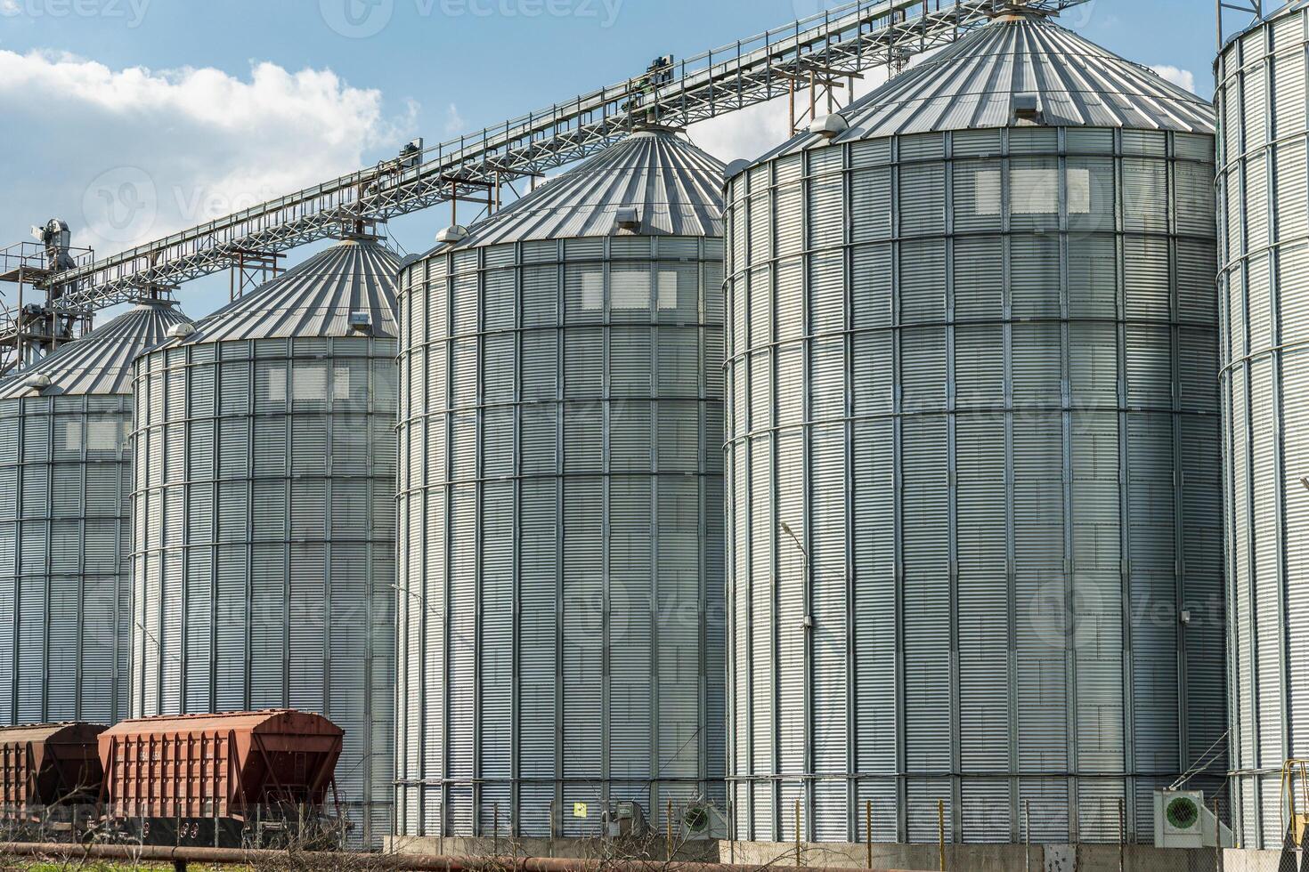 Large silos standing in a farming area illustrate modern storage solutions for harvested grains and crops in an agribusiness context photo