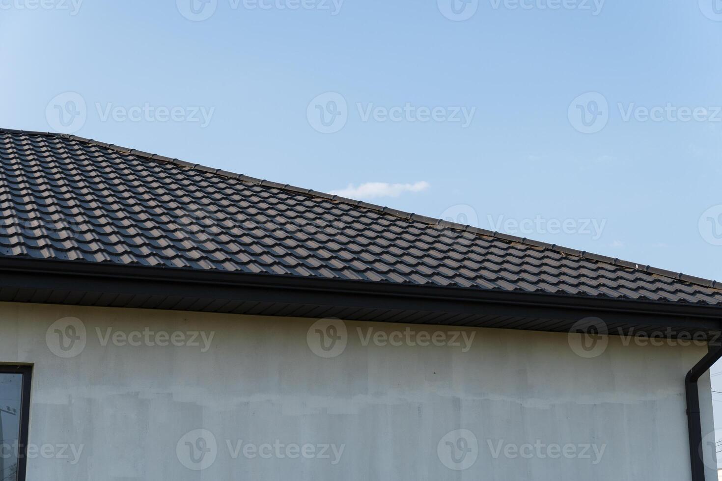 A stylish modern rooftop featuring metallic tiles and a skylight, showcasing contemporary architectural design and home aesthetics photo