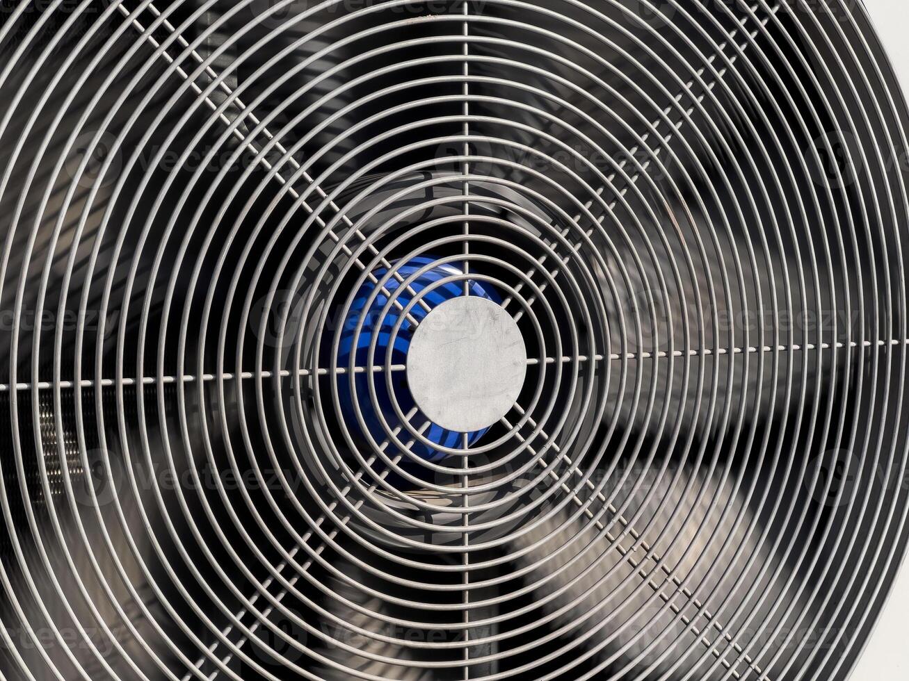 A detailed perspective of a metal fan, showcasing its spiral blades and center, designed for efficient airflow in a warm environment photo