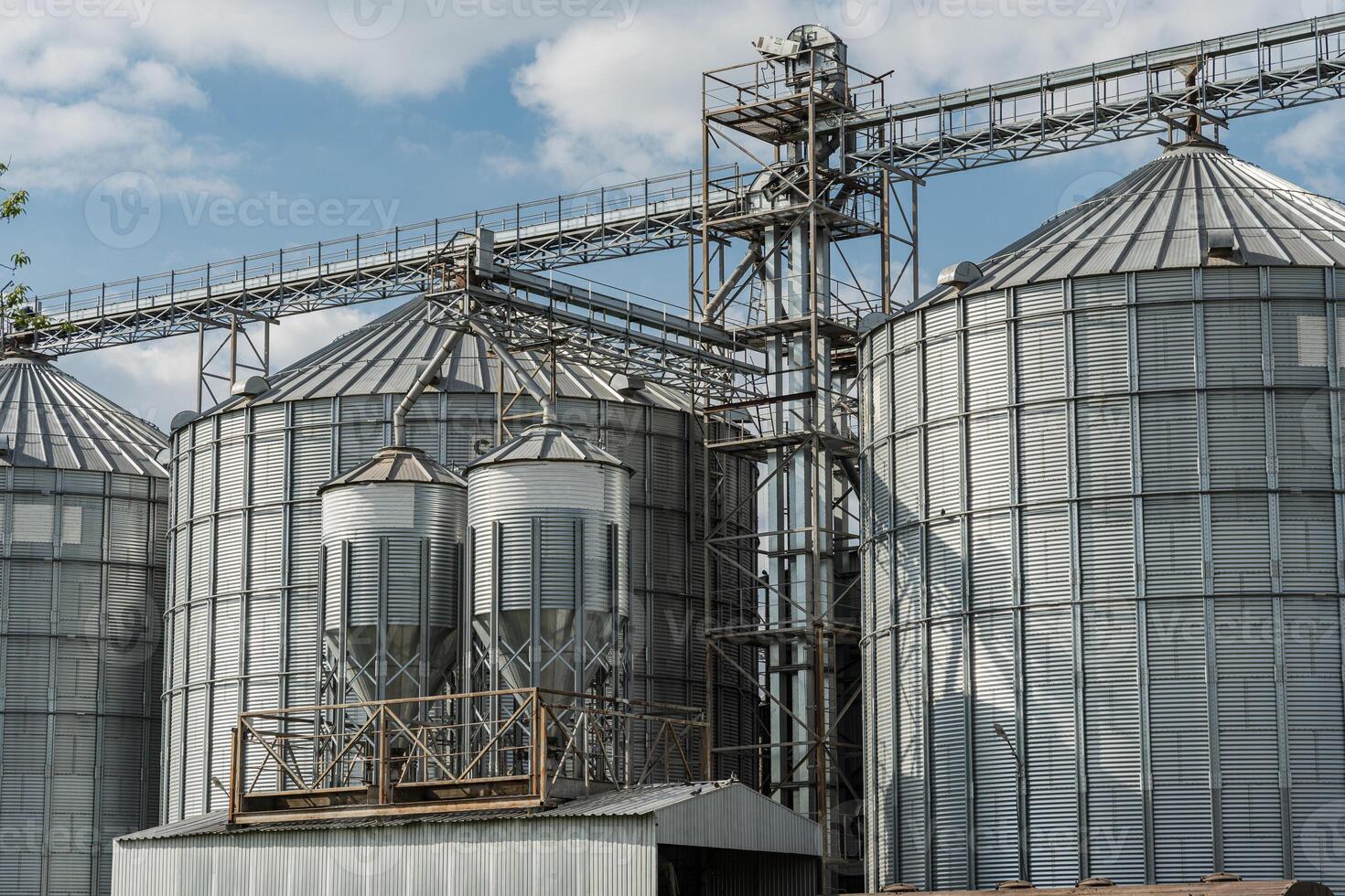 Steel silos and grain bins rise against a clear sky, symbolizing the importance of efficient grain storage in agribusiness and farming operations photo