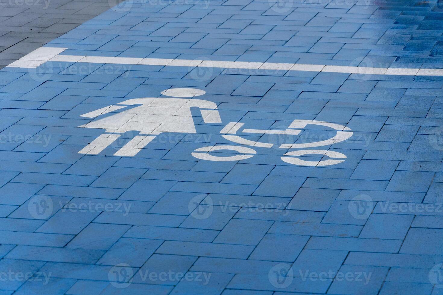 A blue parking space features a clear symbol indicating it is reserved for parents with strollers, promoting convenience photo