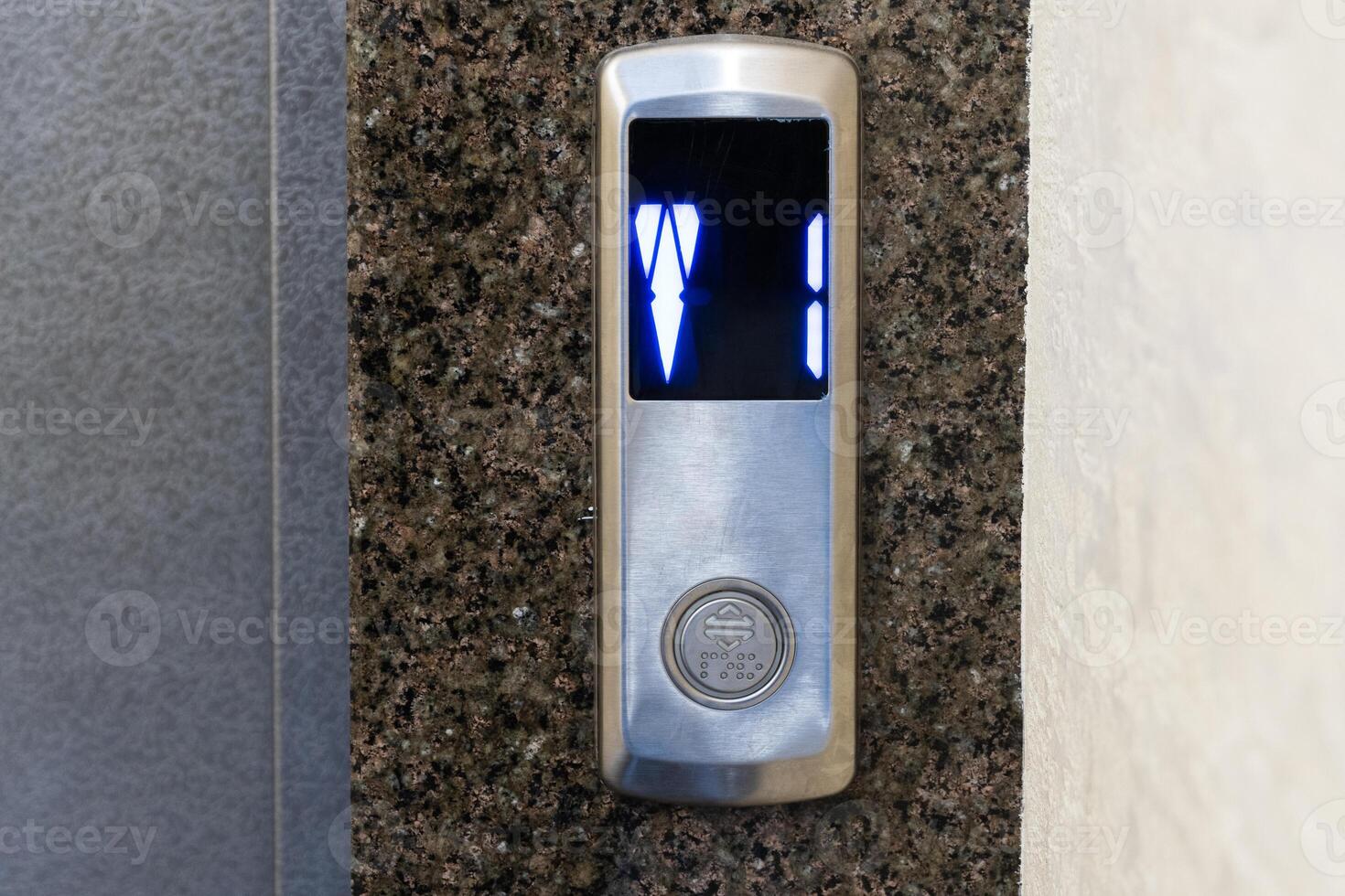 A modern elevator panel shows illuminated floor numbers, blending technology and design in a contemporary urban space photo