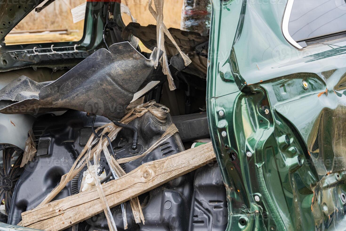 Twisted metal and scattered debris reveal the story of a vehicle's tragic end, showcasing the haunting remnants of a past adventure photo