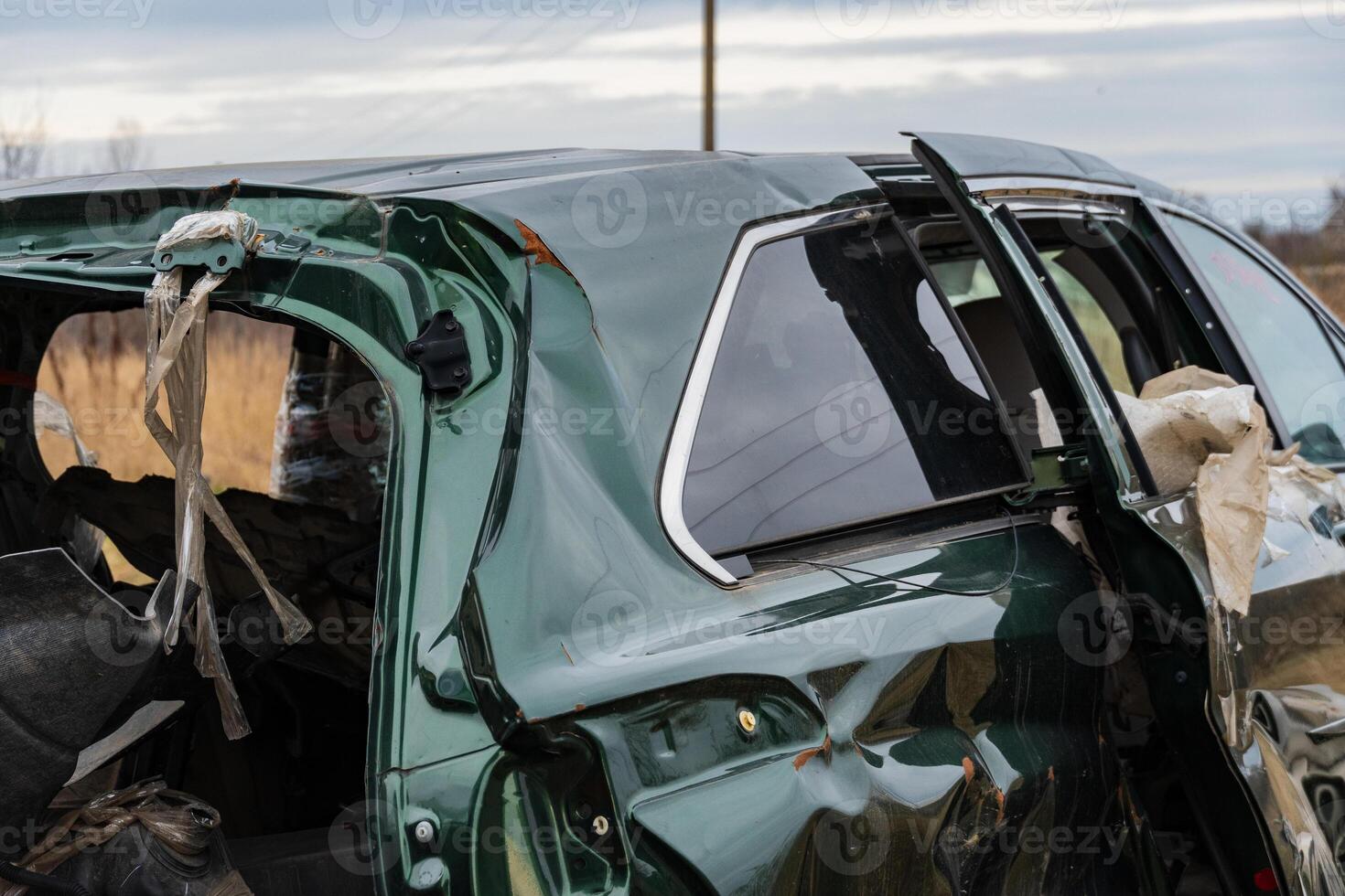 A wrecked vehicle stands motionless on a rural road, showcasing the dangers of car accidents and the aftermath of reckless driving photo