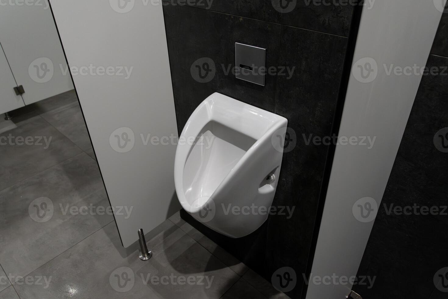 Clean and spacious restroom area features modern urinal design, emphasizing hygiene and minimalist aesthetics within a public facility photo
