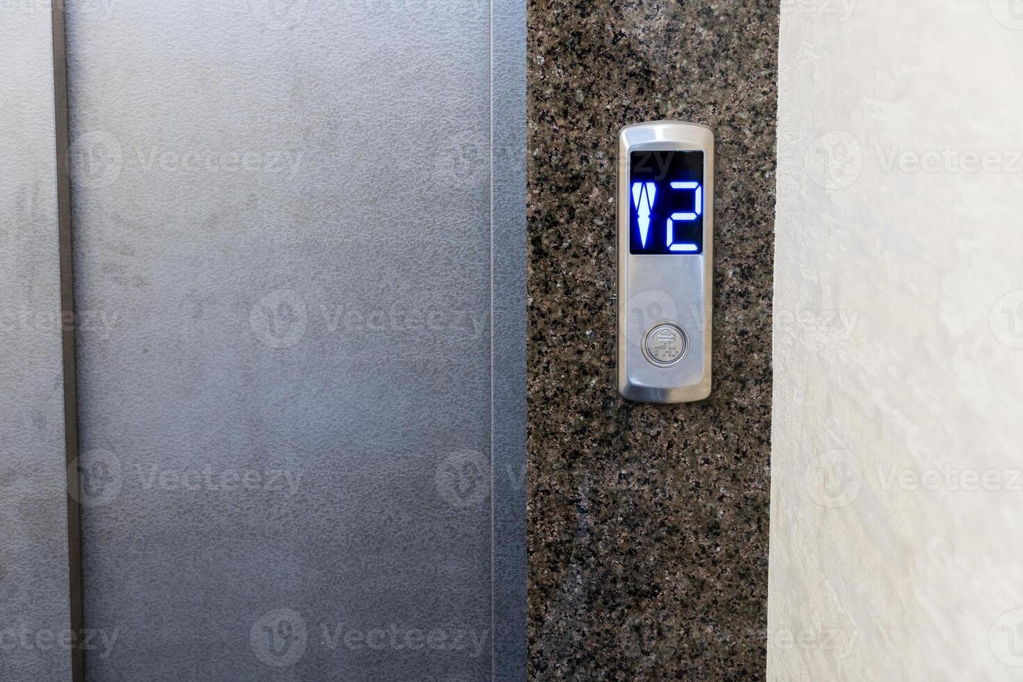 Modern elevator controls seamlessly integrated into a stylish apartment building with illuminated buttons indicating the floor selection photo