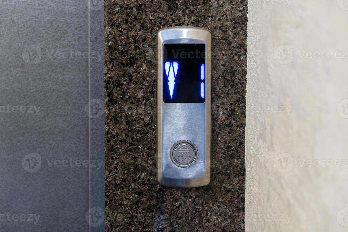 A sleek elevator panel with illuminated floor buttons fits perfectly with the apartment's modern design photo