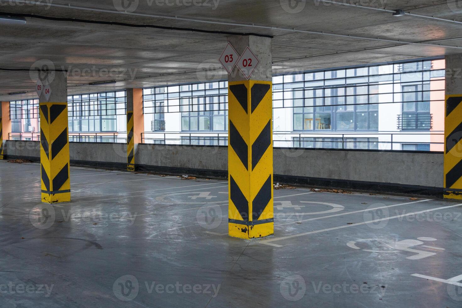 A well-structured parking garage showcases its spaciousness with marked spots and tall columns designed for maximum safety and efficiency photo