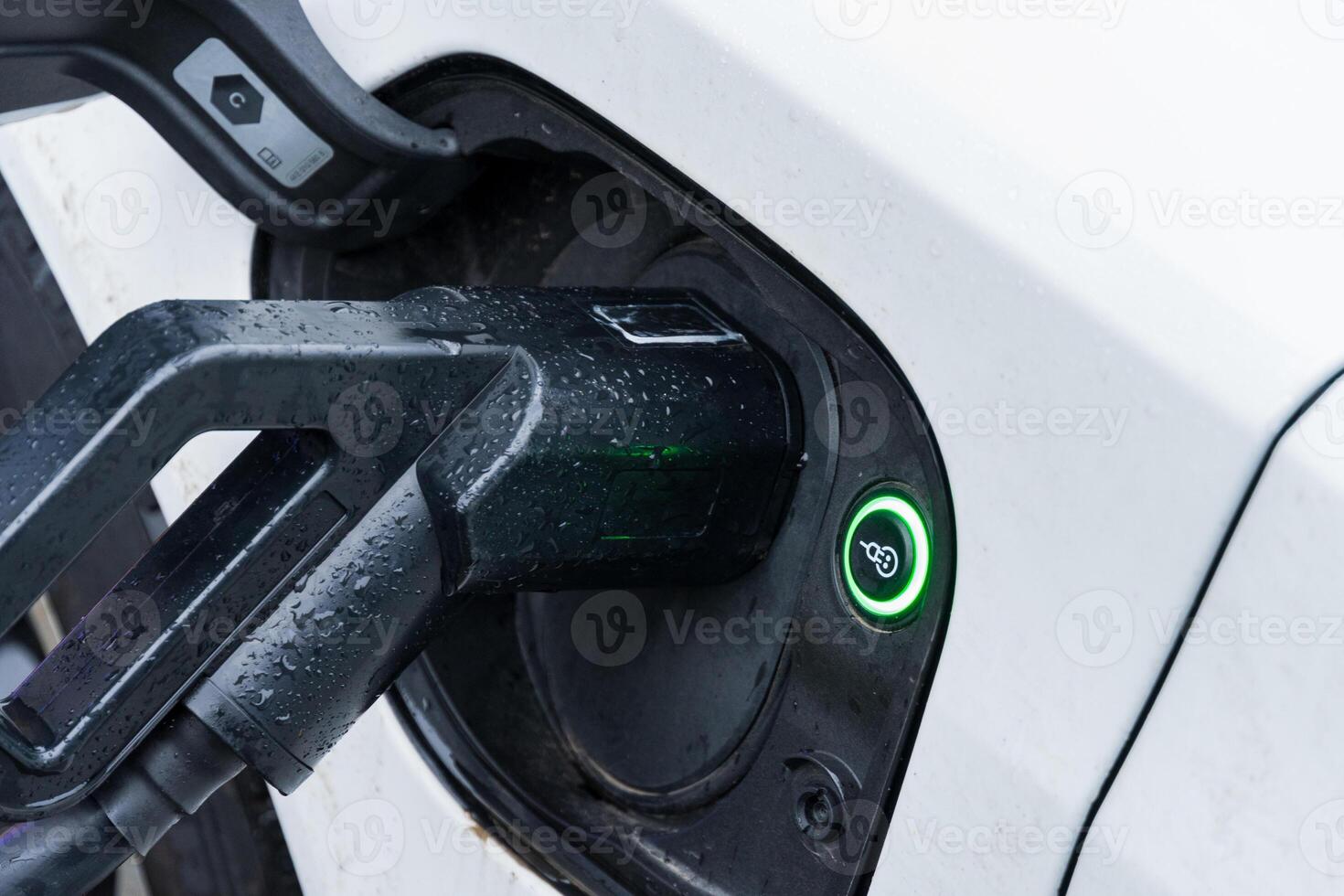 Electric car connects to a charging station, highlighting advancements in transportation and the shift towards renewable energy sources photo