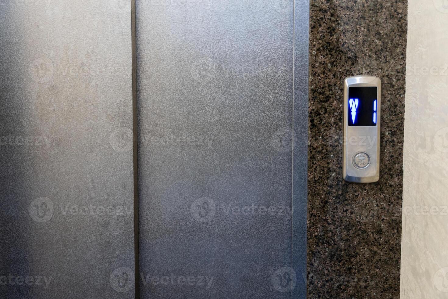 In a stylish apartment, the elevator control panel features illuminated buttons and a seamless steel design, ideal for effortless transportation photo